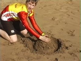 Jered tries his hand at sandcastle-building at Hemmick Beach, Boswinger